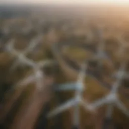 Aerial view of an expansive onshore wind farm with numerous turbines against a clear sky.